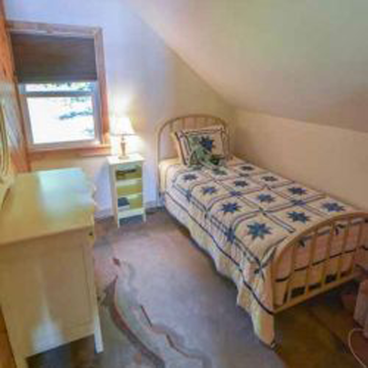 Second bedroom with single bed to the right, dresser to left