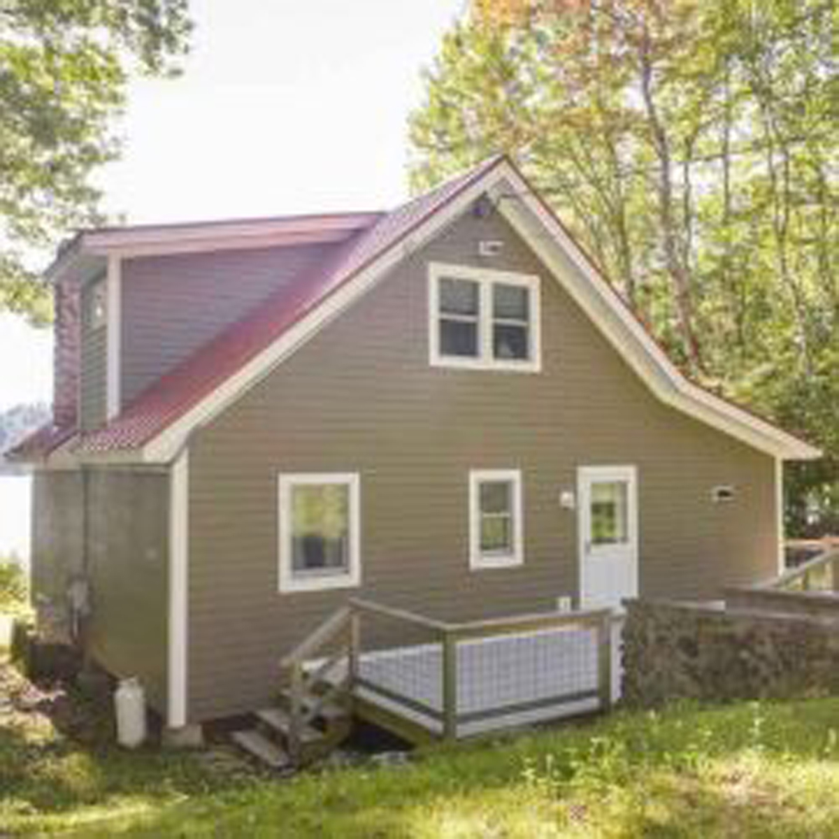 Sunny outdoor shot of whole house looking at front door